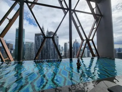a swimming pool on the top of a skyscraper at Infini Suites@ Scarletz Suites KLCC in Kuala Lumpur