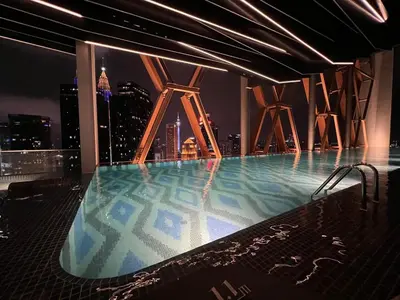 a swimming pool on top of a building with a city skyline at Infini Suites@ Scarletz Suites KLCC in Kuala Lumpur
