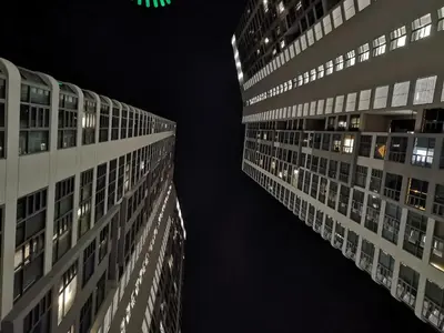 two tall buildings at night in a city at Orion Suites@ The Robertson Bukit Bintang in Kuala Lumpur