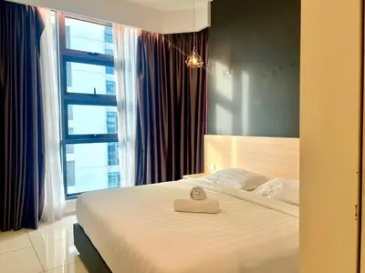a bedroom with a bed with a towel on it at Orion Suites@ The Robertson Bukit Bintang in Kuala Lumpur
