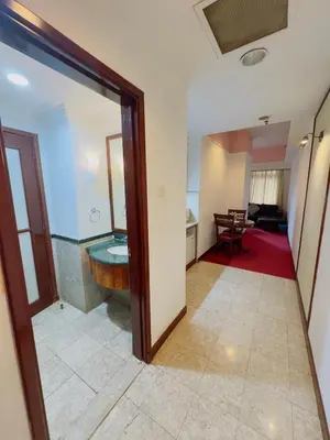 a hallway with a room with a tub and a living room at Times Square East privite service Apartment in Kuala Lumpur