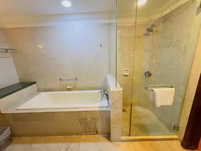 a bathroom with a bath tub and a shower at Times Square East privite service Apartment in Kuala Lumpur