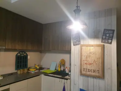 a kitchen with a light and a counter with a laptop at Studio near KLCC and LRT with superb view in Kuala Lumpur