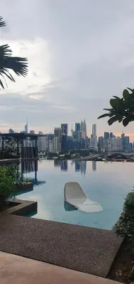 a white boat sitting in the water with a city at Studio near KLCC and LRT with superb view in Kuala Lumpur