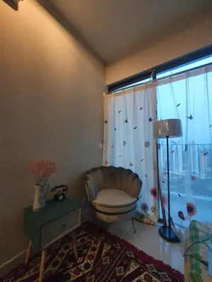 a living room with a chair and a window at Studio near KLCC and LRT with superb view in Kuala Lumpur