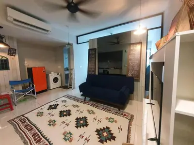 a living room with a blue couch and a rug at Studio near KLCC and LRT with superb view in Kuala Lumpur