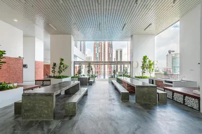 a lobby with benches and a view of the city at Chambers Premier Suites Kuala Lumpur in Kuala Lumpur