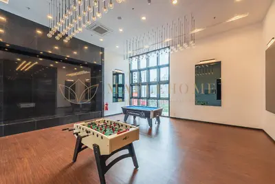 a room with a foosball table in the middle at Chambers Premier Suites Kuala Lumpur in Kuala Lumpur