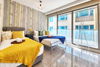 a bedroom with two beds and a large window at 1-6px Bukit Bintang 1min walk to Lot10 Pavilion in Kuala Lumpur