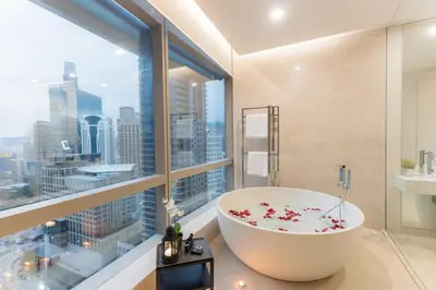 a bathroom with a large tub and a large window at Atelier Bukit Bintang in Kuala Lumpur