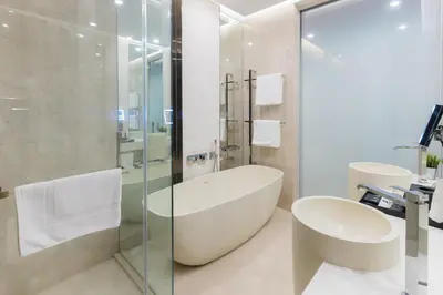 a bathroom with a tub and a glass shower at Atelier Bukit Bintang in Kuala Lumpur