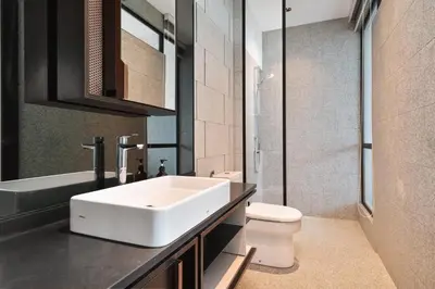 a bathroom with a white sink and a toilet at Scarletz KLCC Apartments by soulasia in Kuala Lumpur