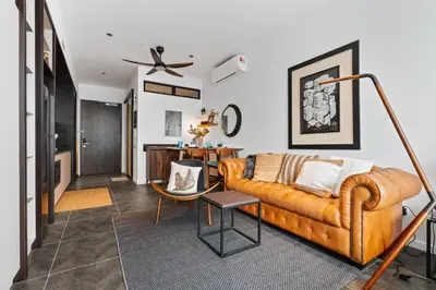 a living room with a couch and a table at Scarletz KLCC Apartments by soulasia in Kuala Lumpur