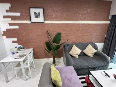 a living room with a couch and a table at Mercu Summer Suite KLCC by Minshuku in Kuala Lumpur
