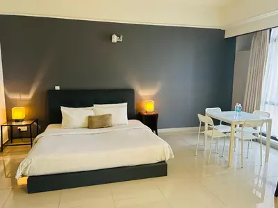 a bedroom with a bed and a table and chairs at MN SUITE At TIMES SQUARE KL in Kuala Lumpur