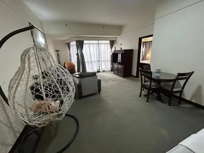 a living room with a table and a net at MN SUITE At TIMES SQUARE KL in Kuala Lumpur
