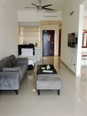 a living room with a couch and a bed at MN SUITE At TIMES SQUARE KL in Kuala Lumpur