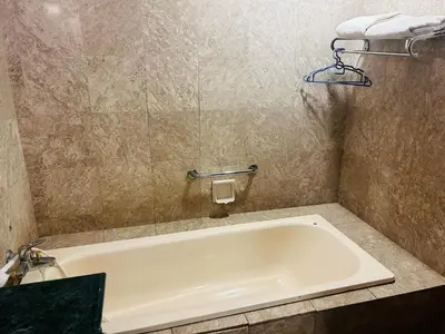 a bath tub in a bathroom with a sink at MN SUITE At TIMES SQUARE KL in Kuala Lumpur