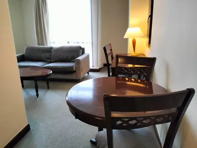 a living room with a table and chairs and a couch at MN SUITE At TIMES SQUARE KL in Kuala Lumpur