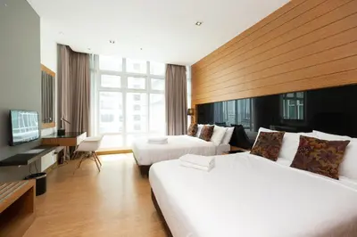 a hotel room with two beds and a television at Dua Sentral Residence near KL Sentral by COBNB in Kuala Lumpur