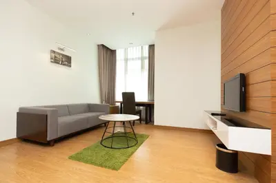 a living room with a couch and a table at Dua Sentral Residence near KL Sentral by COBNB in Kuala Lumpur