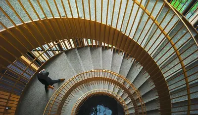 a man walking down a spiral staircase in a building at Premium Suites by Home Horizon at Lucentia Residence in Kuala Lumpur
