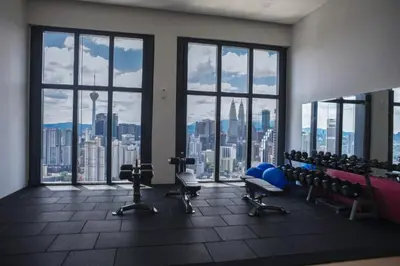 a gym with chairs and a view of the city at Premium Suites by Home Horizon at Lucentia Residence in Kuala Lumpur