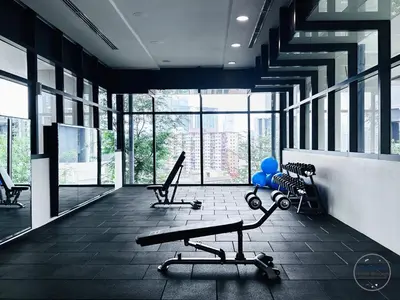 a gym with two chairs and a bench and windows at Premium Suites by Home Horizon at Lucentia Residence in Kuala Lumpur