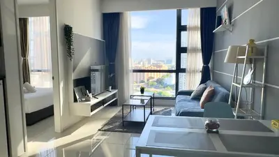 a living room with a couch and a large window at The Robertson Residence Bukit Bintang 20F in Kuala Lumpur
