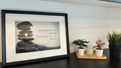 a picture frame sitting on a table with plants at The Robertson Residence Bukit Bintang 20F in Kuala Lumpur
