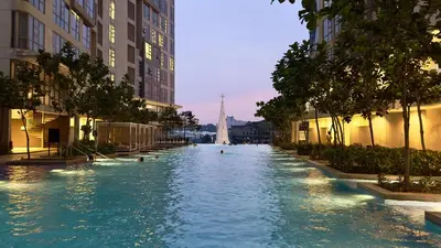 a swimming pool in a city with people swimming in it at The Robertson Residence Bukit Bintang 20F in Kuala Lumpur