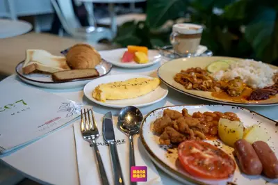 a table with plates of food on a table at Ceylonz KLCC by Mana-Mana in Kuala Lumpur