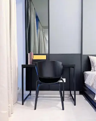 a black chair sitting next to a desk in a bedroom at Tropicana The Residence LV Suite with KLCC View in Kuala Lumpur