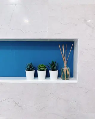 four potted plants sitting on a white shelf at Tropicana The Residence LV Suite with KLCC View in Kuala Lumpur