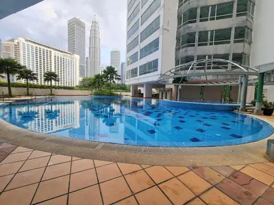a large swimming pool in the middle of a city at Crest Residence Klcc by Sarah's Lodge in Kuala Lumpur