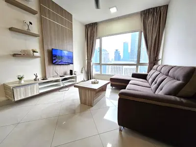 a living room with a couch and a large window at Crest Residence Klcc by Sarah's Lodge in Kuala Lumpur