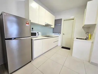 a kitchen with a stainless steel refrigerator and white cabinets at Crest Residence Klcc Bukit Bintang by Sarah's Lodge in Kuala Lumpur