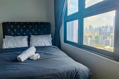a bed with a towel on it with a window at Massive KL View at M-Vertica by HCK in Kuala Lumpur