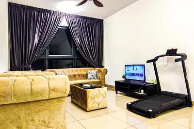 a living room with a couch and a television at Massive KL View at M-Vertica by HCK in Kuala Lumpur