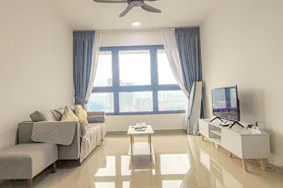 a living room with a couch and a tv at Massive KL View at M-Vertica by HCK in Kuala Lumpur