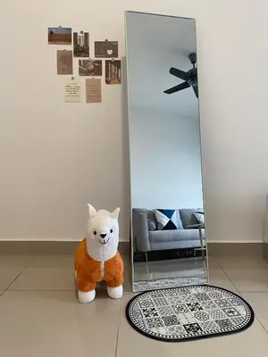 a teddy bear sitting on the floor in front of a mirror at Massive KL View at M-Vertica by HCK in Kuala Lumpur