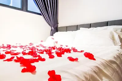 a bunch of red roses laying on a bed at Massive KL View at M-Vertica by HCK in Kuala Lumpur