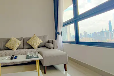 a living room with a couch and a large window at Massive KL View at M-Vertica by HCK in Kuala Lumpur