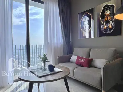 a living room with a couch and a table in front of a window at The Colony by Infinitum Kuala Lumpur in Kuala Lumpur