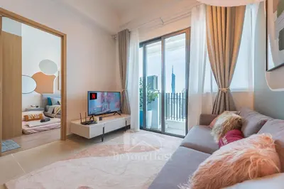 a girl laying on a couch in a living room with a tv at The Colony by Infinitum Kuala Lumpur in Kuala Lumpur