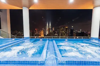 a swimming pool with a city skyline in the background at The Colony by Infinitum Kuala Lumpur in Kuala Lumpur