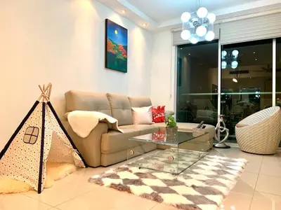 a living room with a couch and a glass table at MITEC Publika 2Br Hot tub Sri Hartamas Mont Kiara in Kuala Lumpur