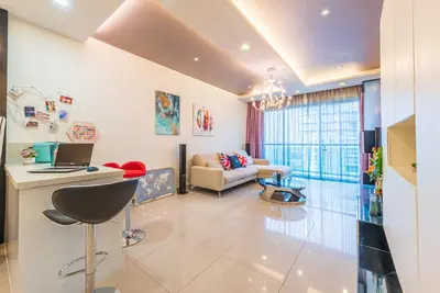a living room with a couch and a table at MITEC Publika 2Br Hot tub Sri Hartamas Mont Kiara in Kuala Lumpur