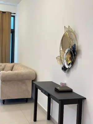 a room with a table and a chair and a mirror at KLCC Kampung Baru Cottage - Homestay in Kuala Lumpur