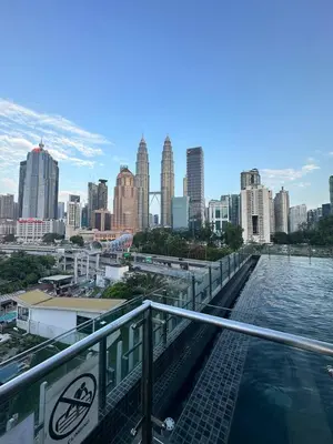 a view of a city skyline with a body of water at KLCC Kampung Baru Cottage - Homestay in Kuala Lumpur